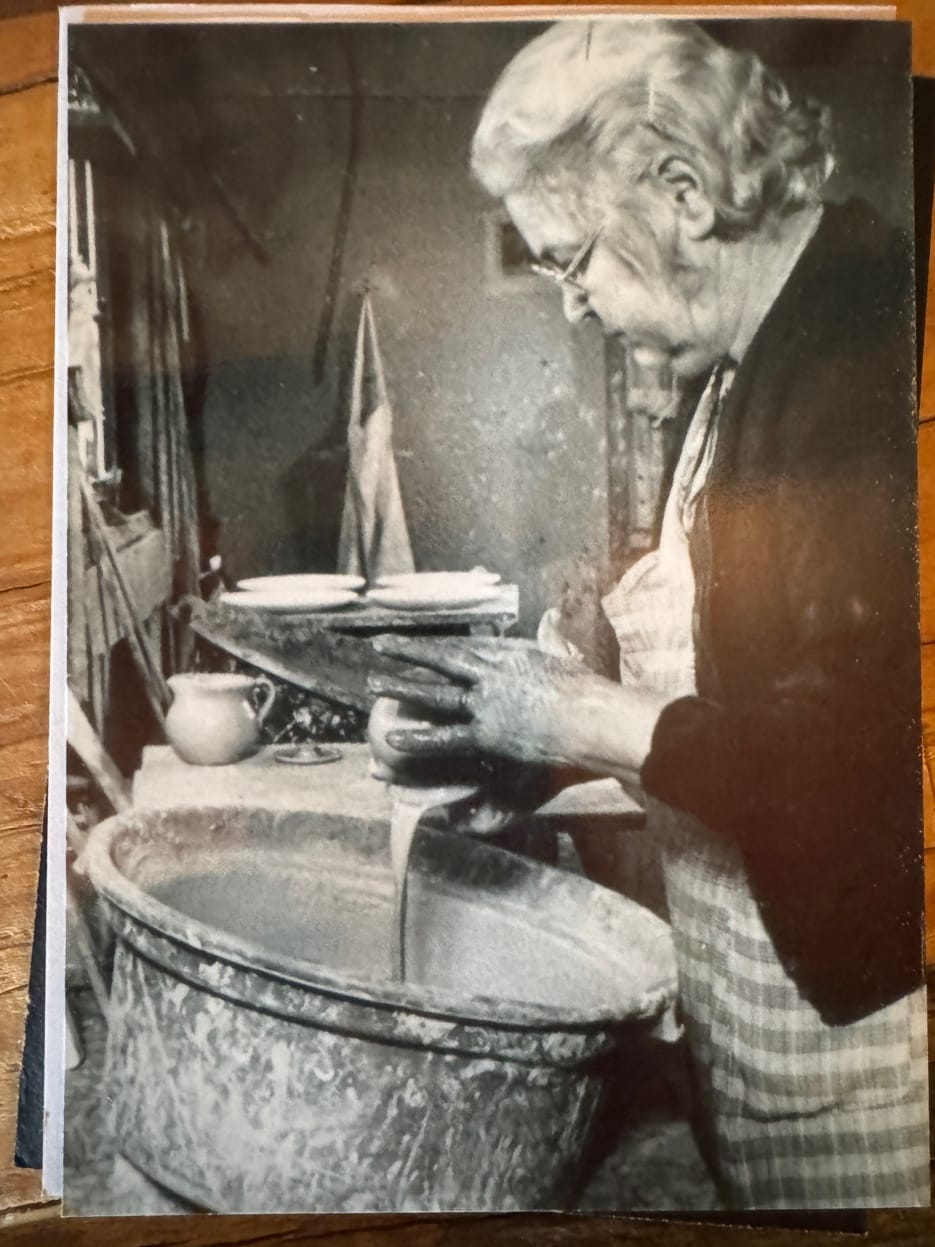 Marie Owens glazing pottery at the Owens shop