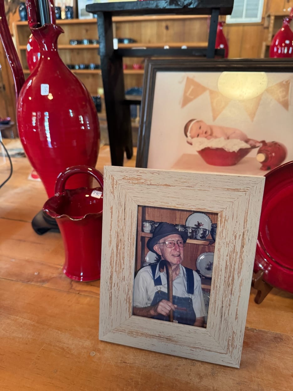 Framed photo of an Owens family patriarch in the pottery shop